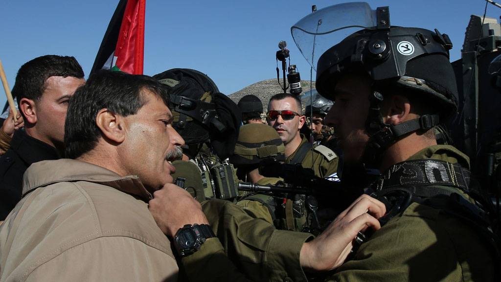 Ziad Abu Ein argues with Israeli troops (Getty)