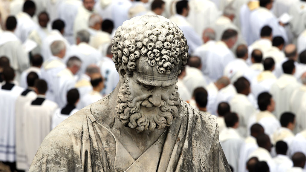 A mass takes place behind St Peter's statue, in the Vatican City's St Peter's Square (R)