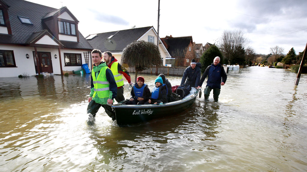 A family is evacuated by boat as the water keeps rising in Wraysbury