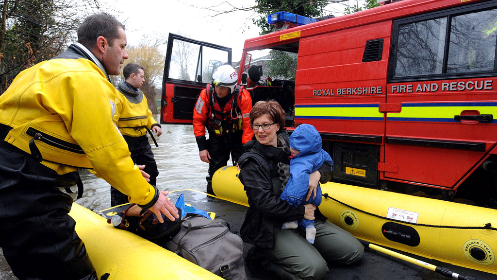 Mum and baby are evacuated from their home in Wraysbury, west of London. (G)