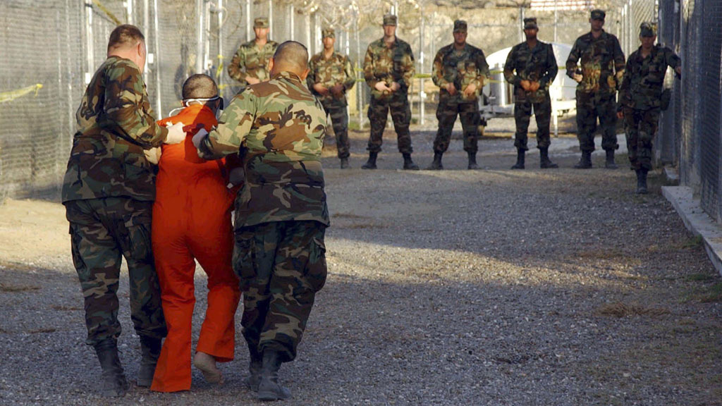 Guantanamo guards with new detainee (Reuters)