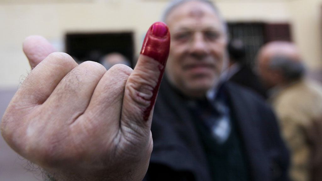 Egypt referendum: voter holds up ink stained finger aftering oting at polling station in Cairo (picture: Reuters)
