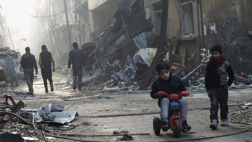 Woman and children allowed to leave Homs (picture: Reuters)