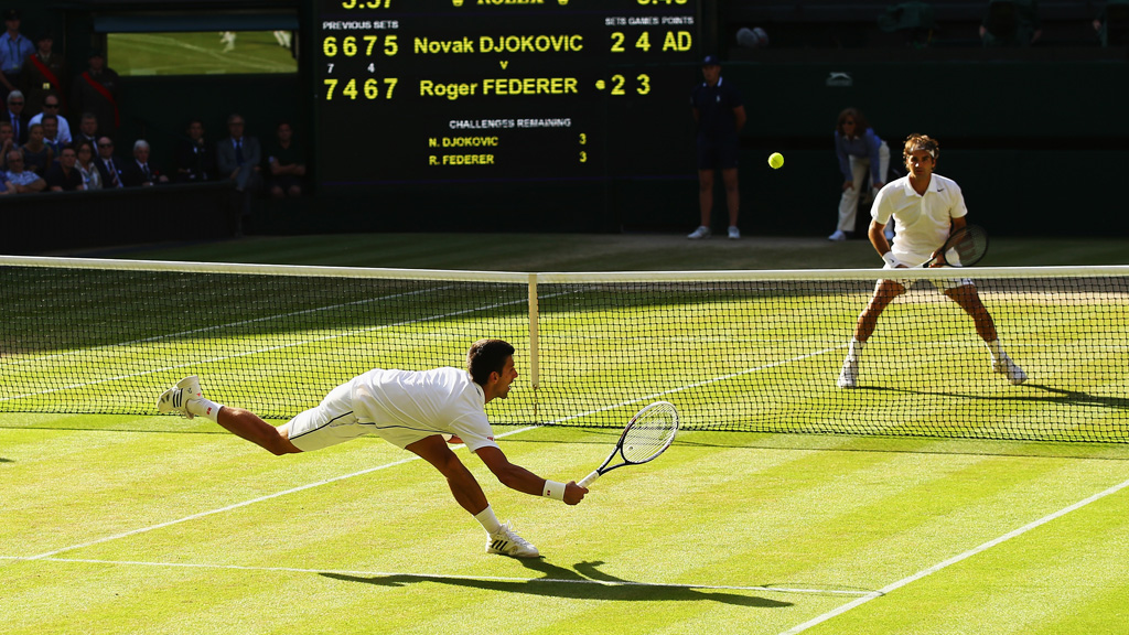 Novak Djokovic dives for the ball in the Wimbledon final