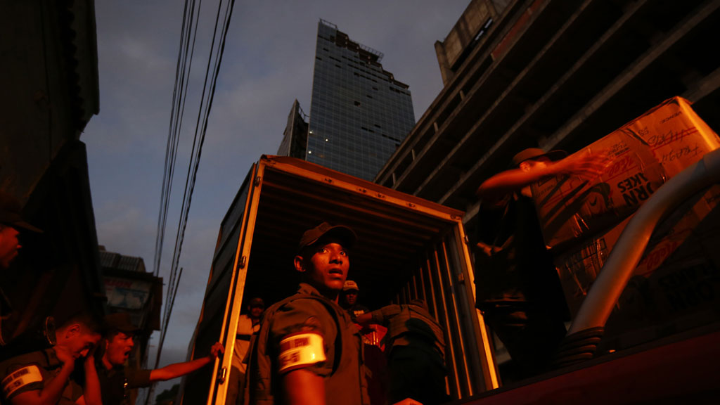 Venezuelan national guard carry into a truck the belongings of evicted Tower of David 