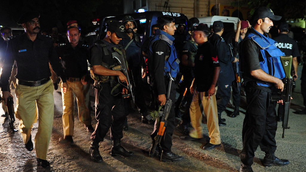 Pakistani security personnel gather outside the Jinnah International Airport after the assault in Karachi (Getty)