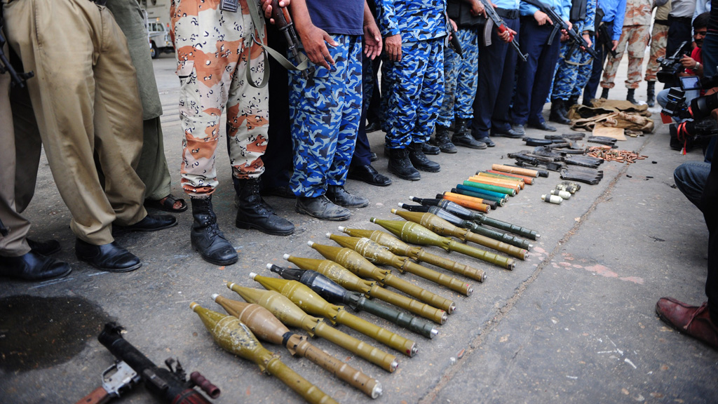 Pakistani policemen show seized weapons from the militants (Getty)