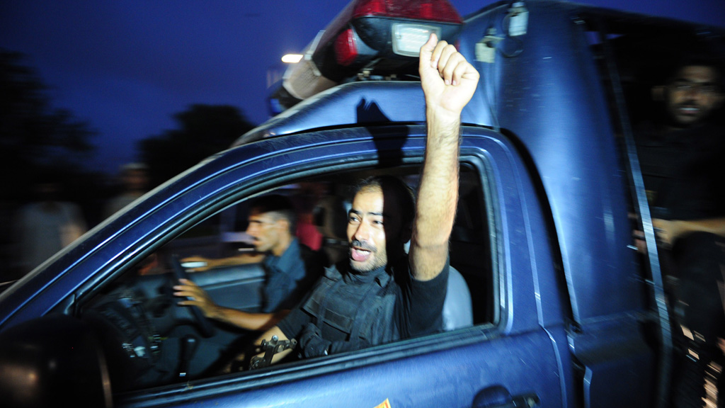 A Pakistani police commando shout slogans on his return from the operation against militants (Getty)