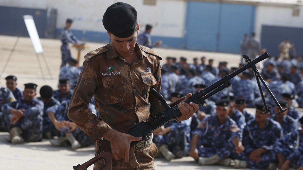 Newly-recruited Iraqi volunteers in police uniforms attend a training session at the Ibrahimiya police camp outside the central Iraqi Shiite city of Karbala (Getty)
