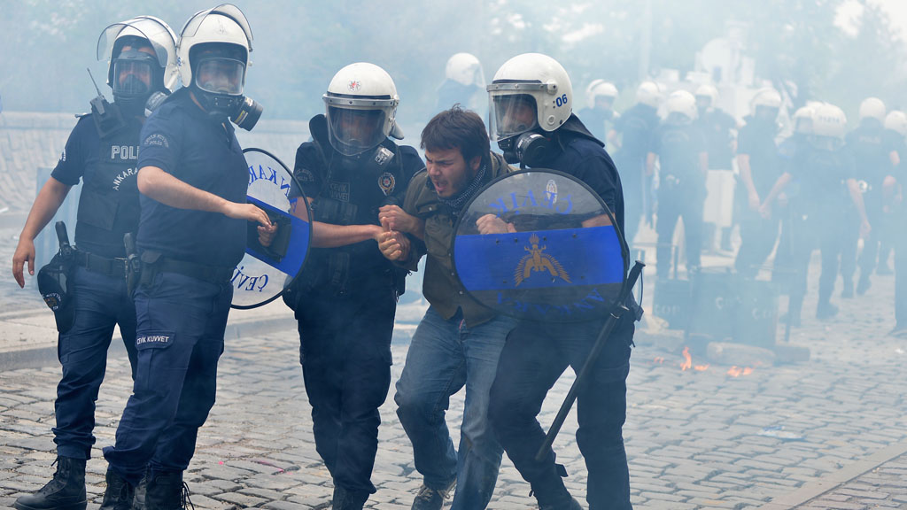 Riot police detain a protester in Ankara (Reuters)