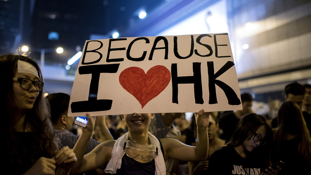 A woman holds a placard at a large pro-democracy protest in Hong Kong (Getty)