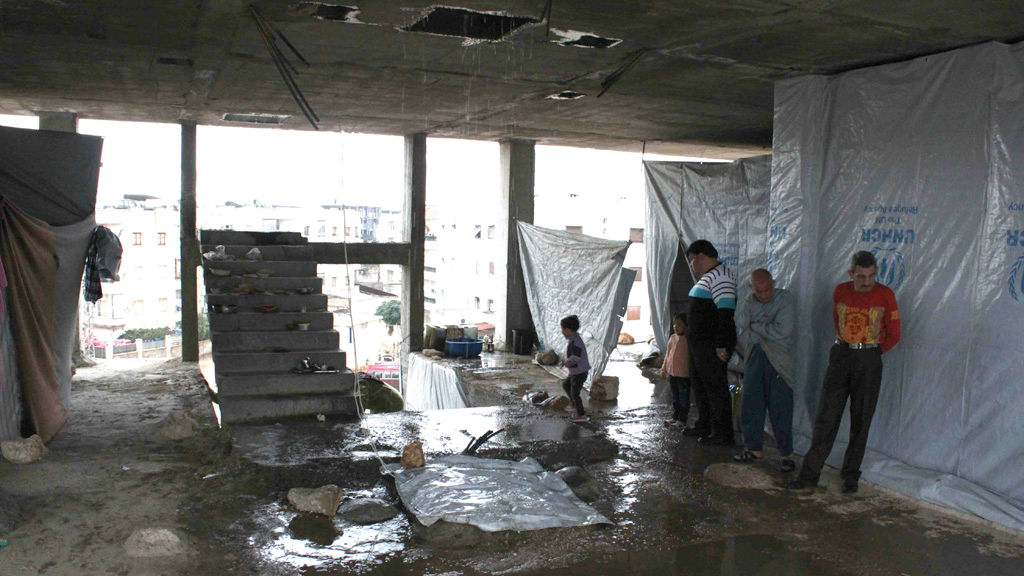Families are living in partially built houses in Aleppo after being displaced by fighting