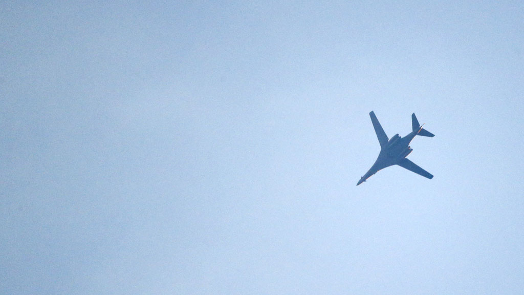 Coalition jet circles above Kobani (Reuters)