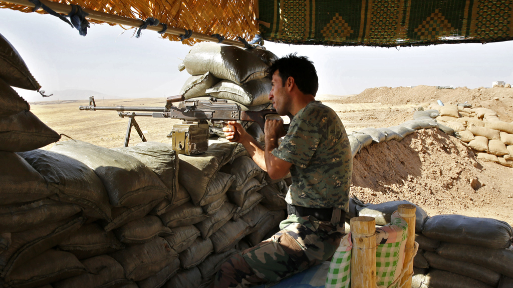 Photo: a Kurdish peshmerga fighter takes up position at the front line against IS, at Khazir near Mosul (R)
