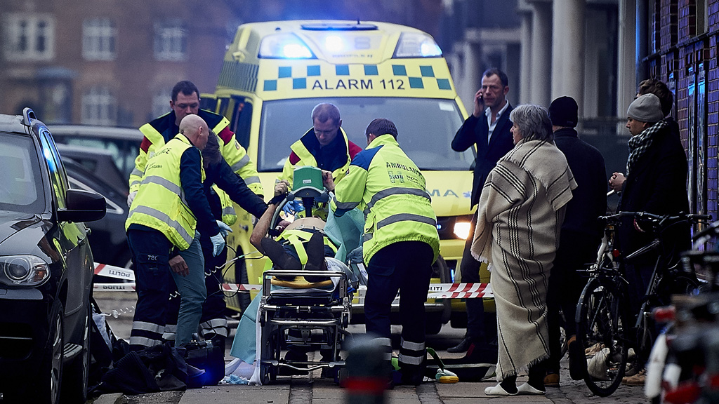 Ambulance staff treat police office wounded in shooting (Getty)