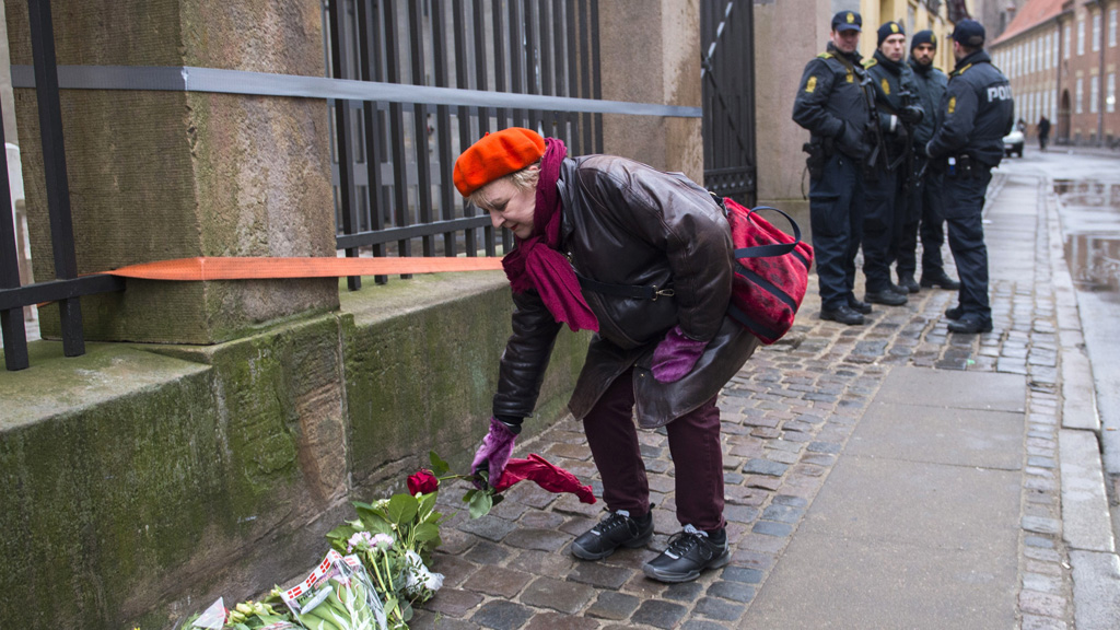 A well-wisher lays flowers near the synagogue in Copenhagen (Getty)