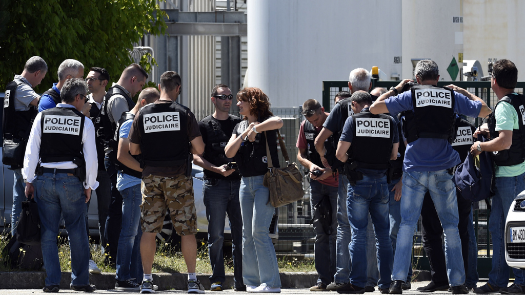 Police gather near the entrance to the factory (Getty)