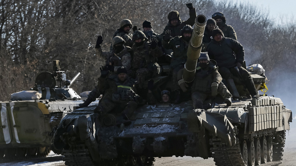 Ukrainian soldiers on a tank as they leave Debaltseve (Reuters)