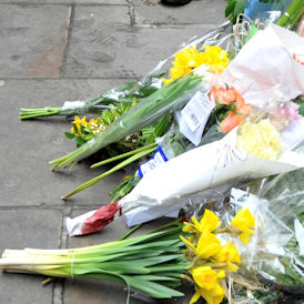 Tributes are laid where Tomlinson died on April 1 during G20 demonstrations in London (Reuters)
