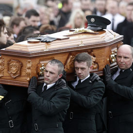PC Ronan Kerr's coffin is carried my police in Northern Ireland. He was killed by a bomb in Omagh on Saturday (Reuters)