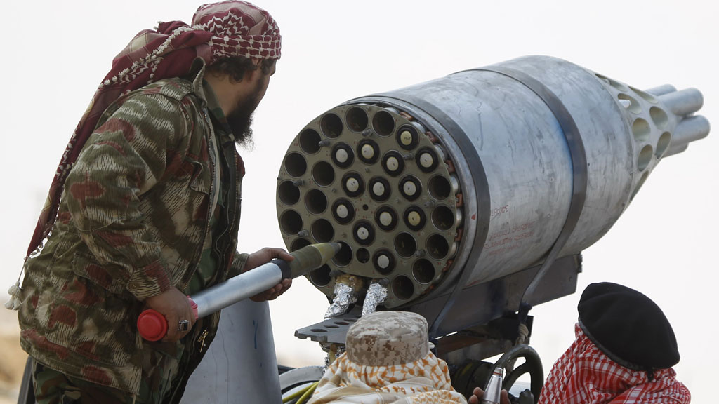 Libya: Rebel fighters man a rocket pod taken from an aircraft mounted on a pickup truck, in the front line along the western entrance of Ajdabiyah (Reuters)