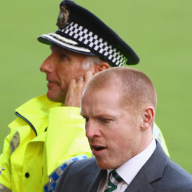Celtic manager Neil Lennon with police protection (Getty)