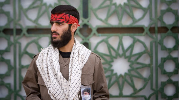 A member of Iran's basij militia with a photo of Ayatollah Ali Khamenei on his uniform. (Reuters)