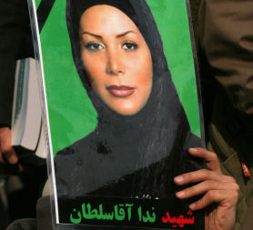 An Iranian opposition supporter holds a picture of Neda Agha Soltan. (Getty)