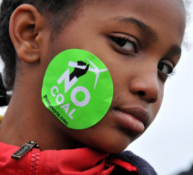A young campaigner displays an anti-coal sticker at a climate change rally outside the White House in Washington. (Getty)