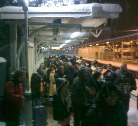 People wait for news on train... in the cold snow