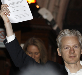 WikiLeaks editor Julian Assange emerges from the High Court. (Reuters)