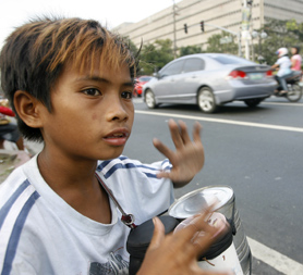 Children begging and singing carols on the streets of Manila (Reuters)