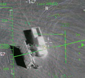 A pilot's display in a ground control station shows a truck from the view of a camera on an MQ-9 Reaper during a training mission. The Reaper is the Air Force's first 