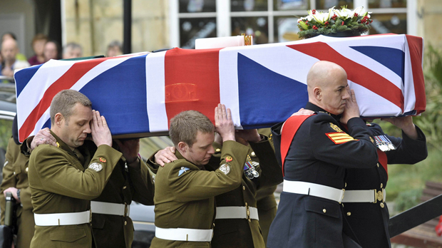 Bomb disposal expert Olaf Schmid's coffin is carried.