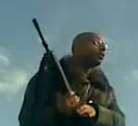 Saif Gaddafi rallies supporters in Libya, with gun.