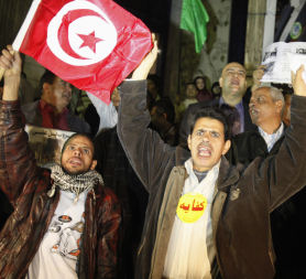 Egyptian protesters wave the Tunisian flag in Cairo (Reuters)