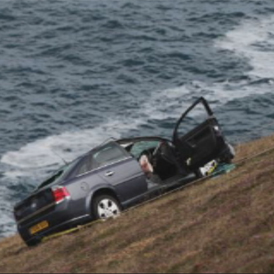 A driver who was inside her car as it plunged over a cliff in north west Cornwall has been rescued after spending the night perched on the face of the 300ft precipice.