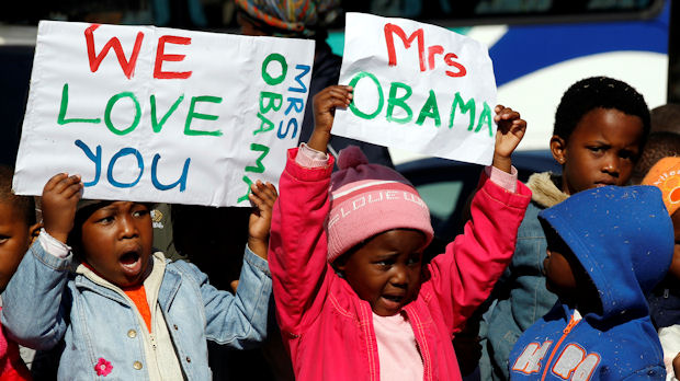 Children holding signs supporting Michelle Obama in Soweto, South Africa (Reuters)