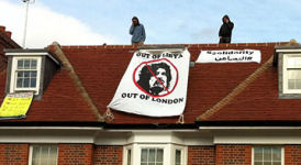 A banner hangs on the roof at Saif Gaddafi's London home. (via Twitter)