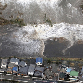 Houses are damaged by water following a tsunami and earthquake in Ibaraki city Japan (Reuters)