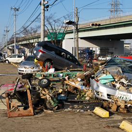 Cars strewn around powerpoles in the wake of Japan's earthquake and tsunami.