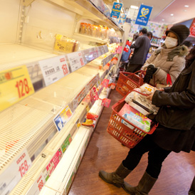 Empty shelves in a Japanese supermarket after radiation concerns fuelled panic-buying.