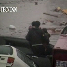 A local reporter films terrifying eyewitness footage of the tsunami striking Northern Japan and then the desperate efforts to rescue men, women and children from the rising flood waters. 