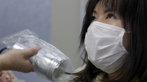 A woman who was evacuated from Fukushima undergoes a test for signs of nuclear radiation at a health centre in northern Japan (Reuters)