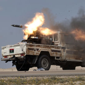 Libyan rebels fire a rocket near Brega. They are being forced to retreat in the face of Gaddafi's advancing forces (Getty)