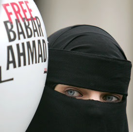 A protester holds up a sign calling for Babar Ahmad's release (Reuters)
