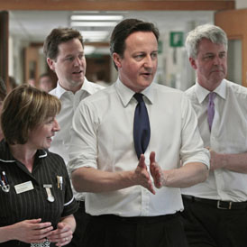 Andrew Lansley (right) with David Cameron and Nick Clegg during a hospital visit (Reuters)