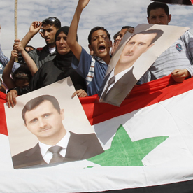 Syrian people living in Jordan shout slogans during a demonstration to show support for Syria's President Assad in Amman (Reuters)