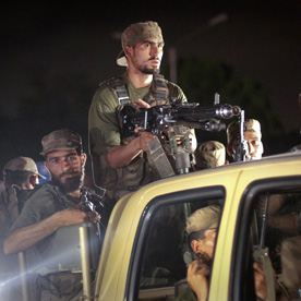 Army soldiers arrive at the Mehran naval aviation base (Reuters)