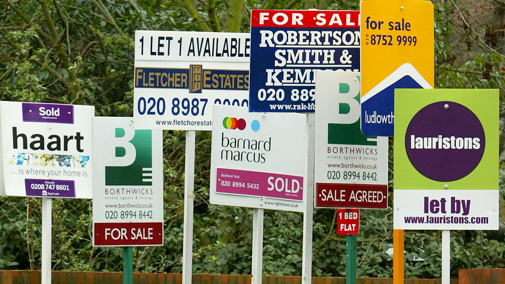 A picture of estate agents boards as a survey finds most first time buyers don't think they will ever be able to afford their own home